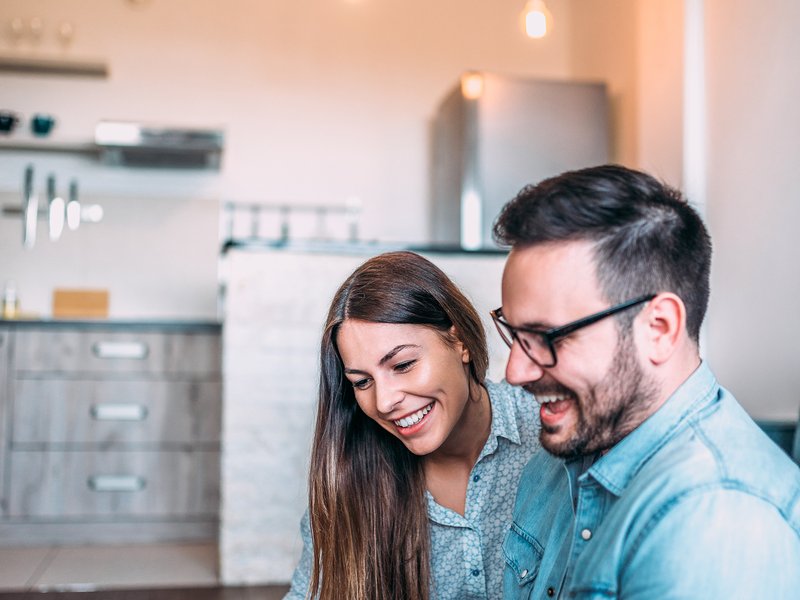 Couple looking at phone and online shopping