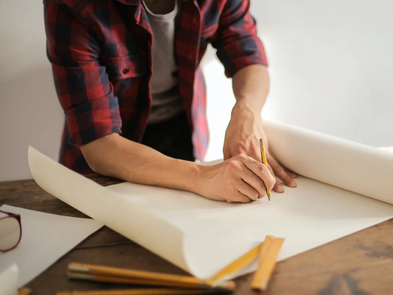 Worker drafting up estimates on a home